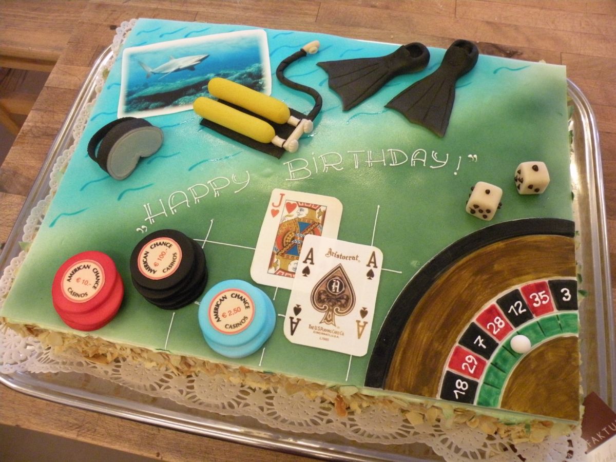 Hobby-themed cake with hunting, fishing, cards, roulette wheel, and dice decorations