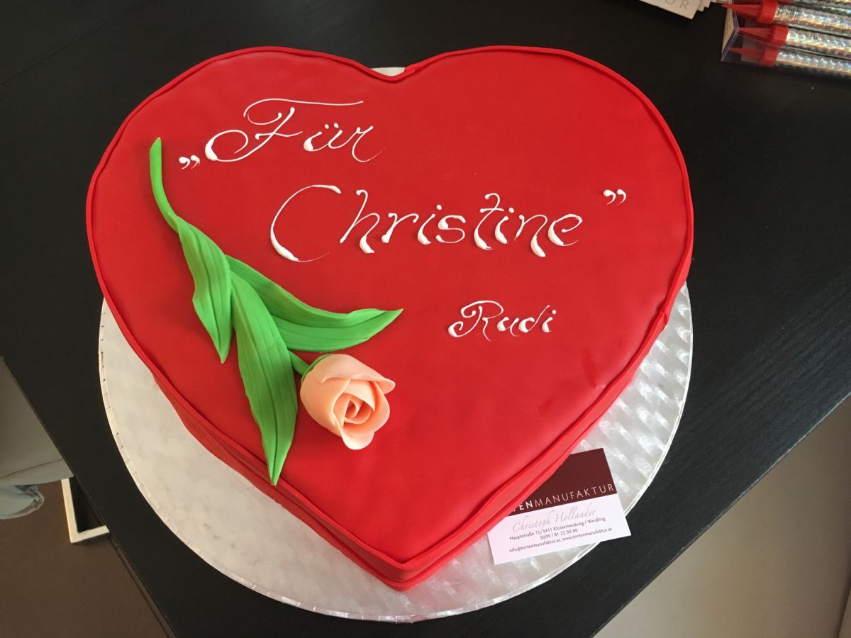 Heart-shaped red birthday cake with peach fondant rose