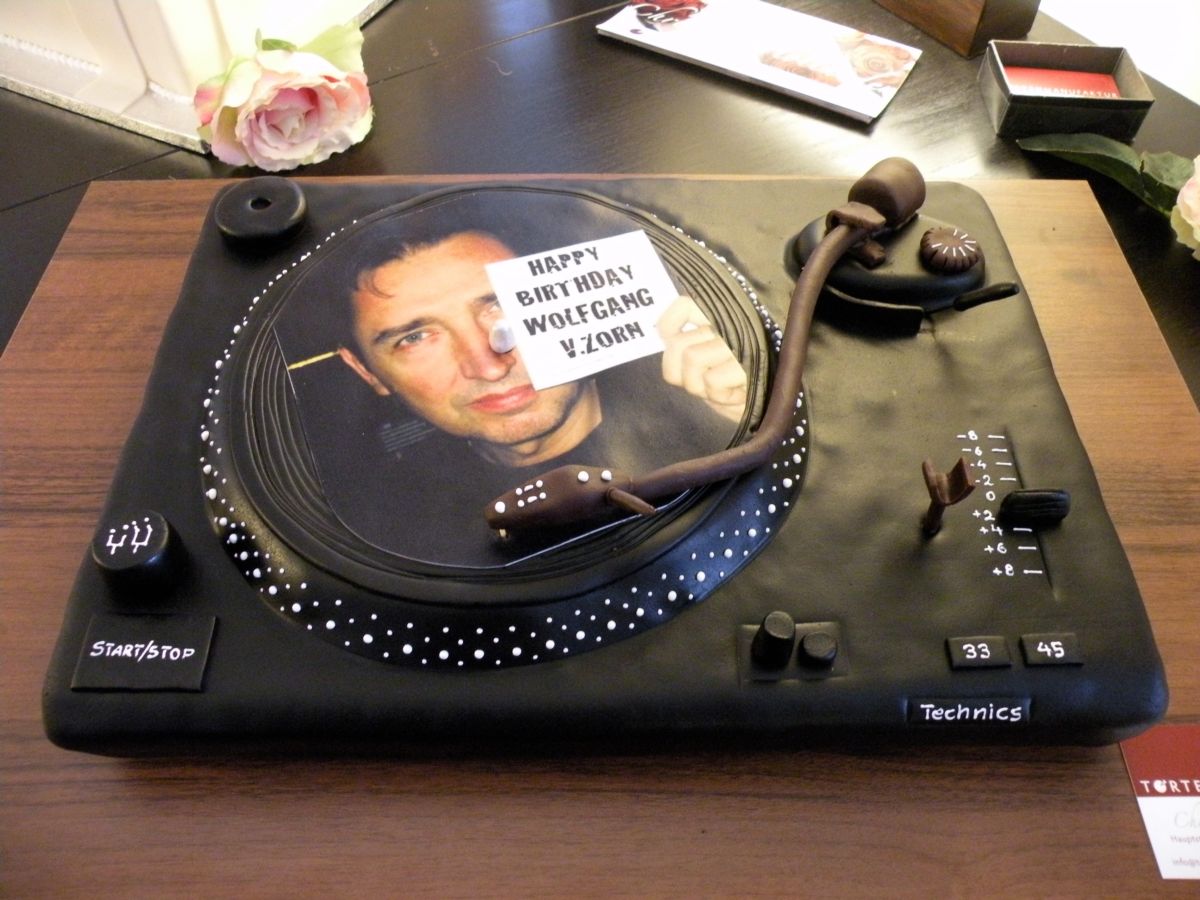 DJ turntable cake in black with vinyl record image and headphones detail