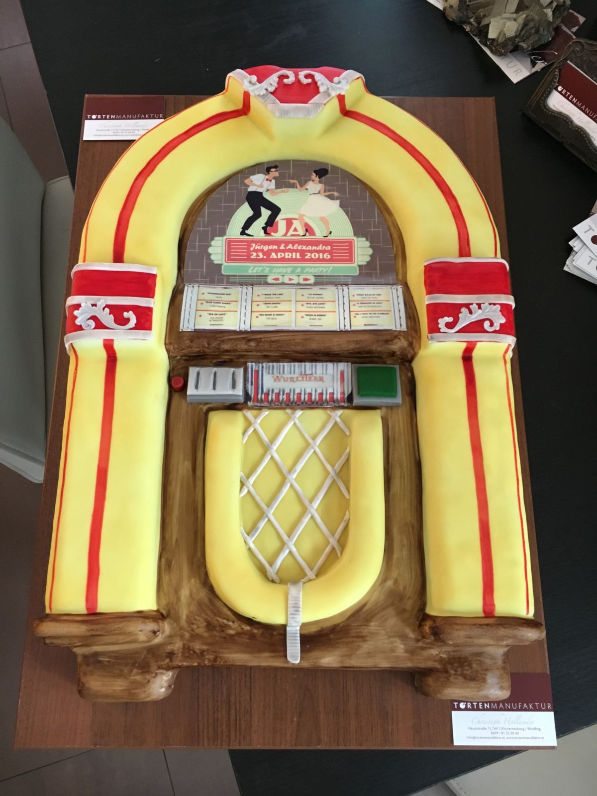 Retro jukebox cake in yellow and red with period details