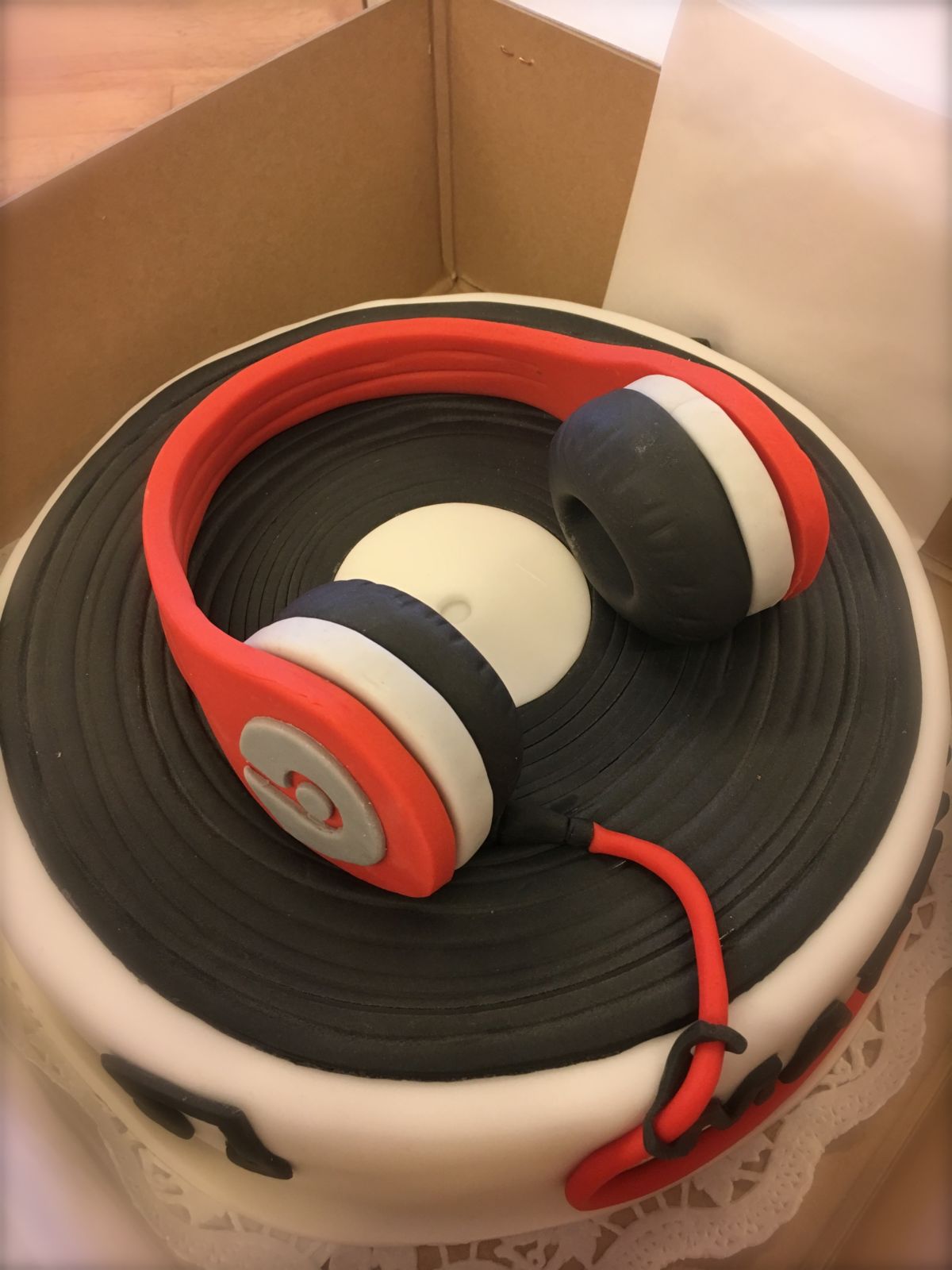 Headphones cake in red and black on vinyl record base