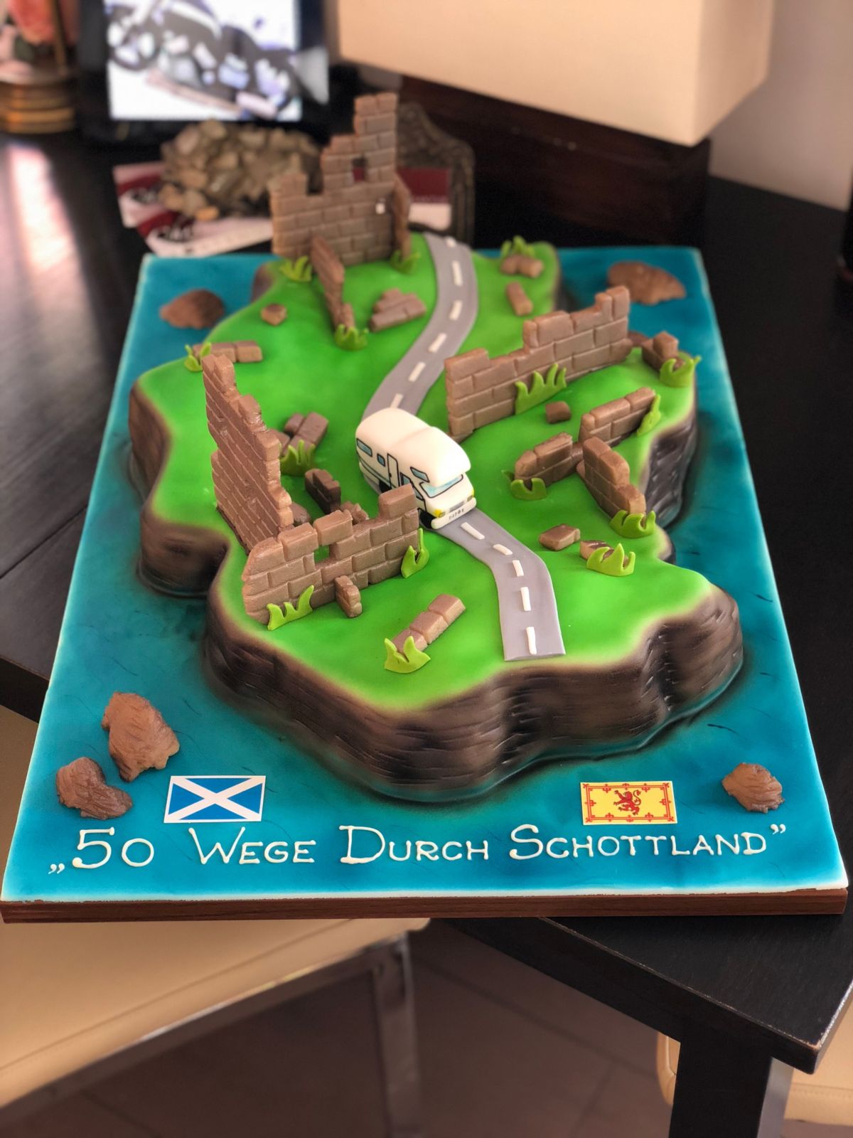 Scotland landscape cake with stone buildings and winding road