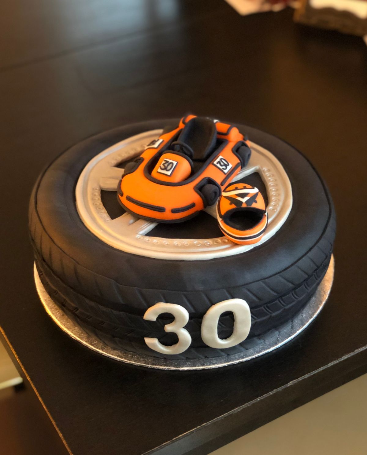 Sports motorcycle cake with tyre texture and helmet model
