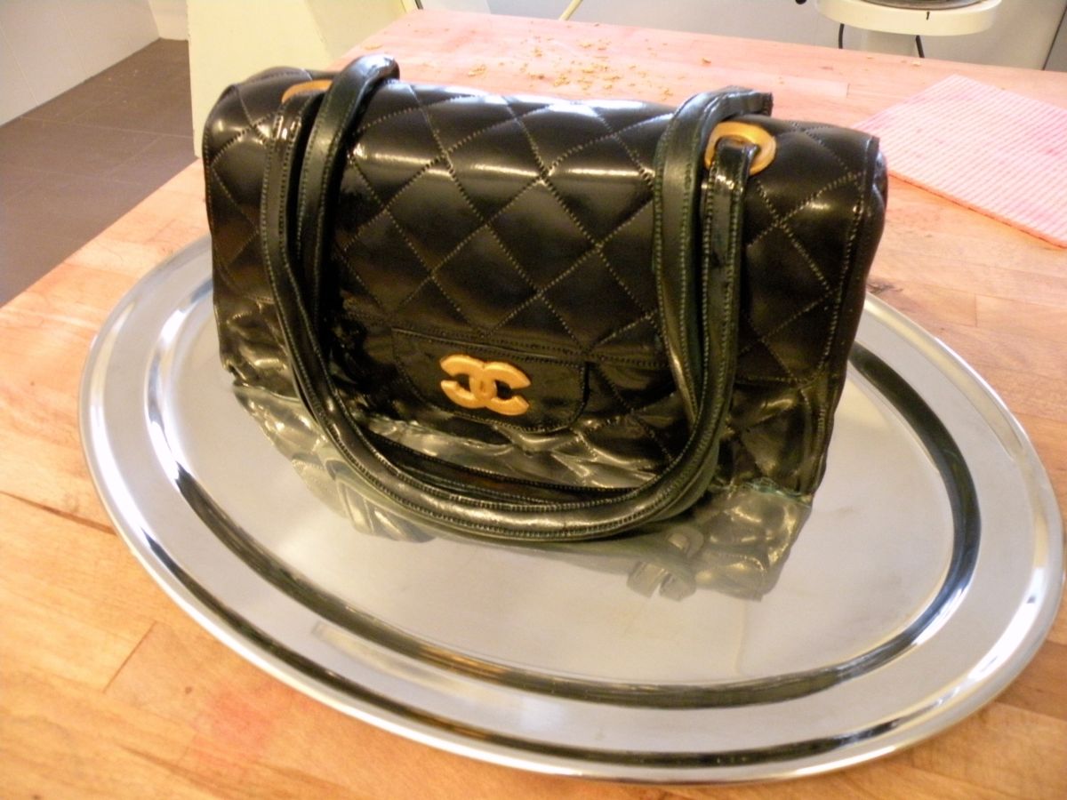 Black quilted handbag cake with gold chain handles and hardware details