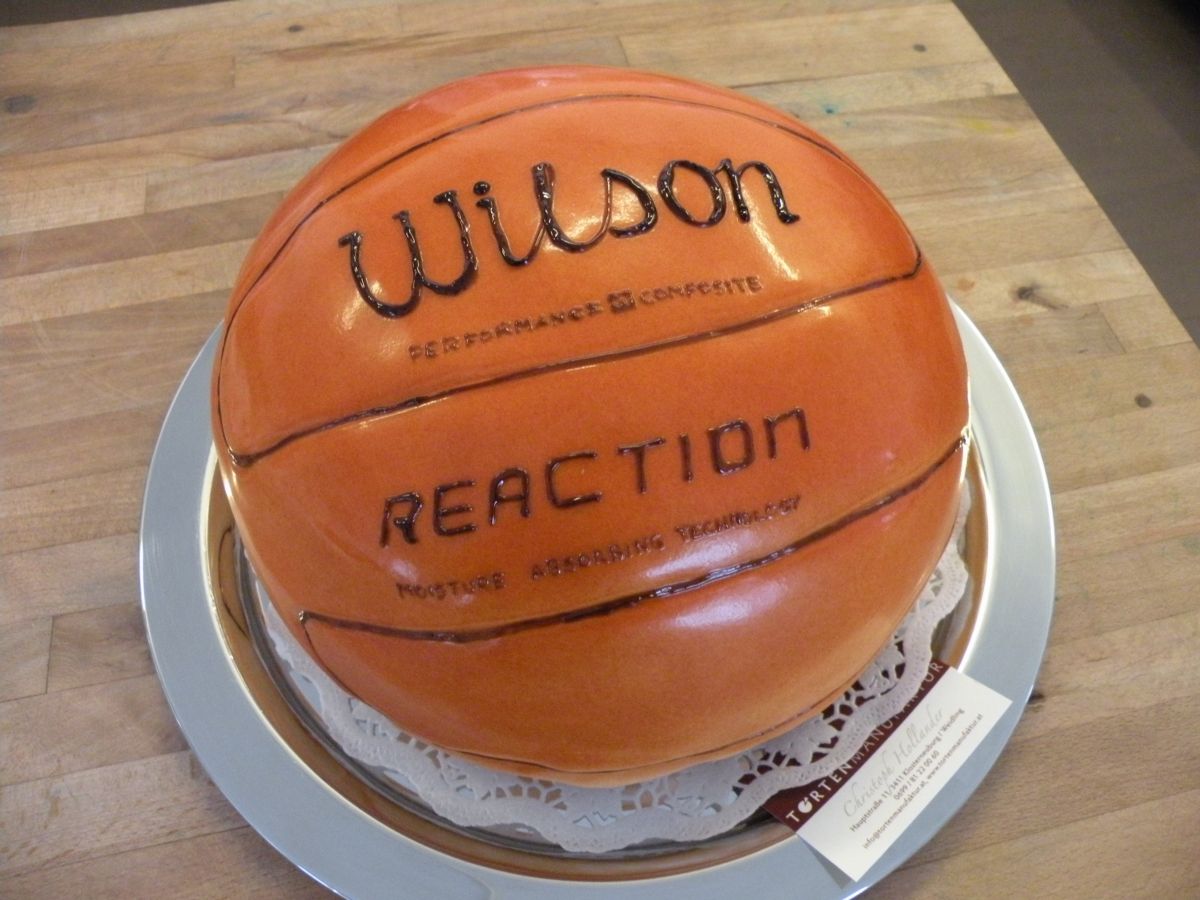 Orange basketball-shaped cake with Wilson branding and authentic stitching