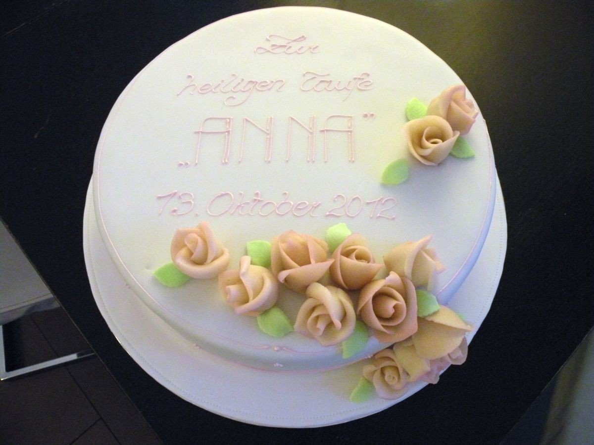 Oval christening cake with fondant roses in peach and cream