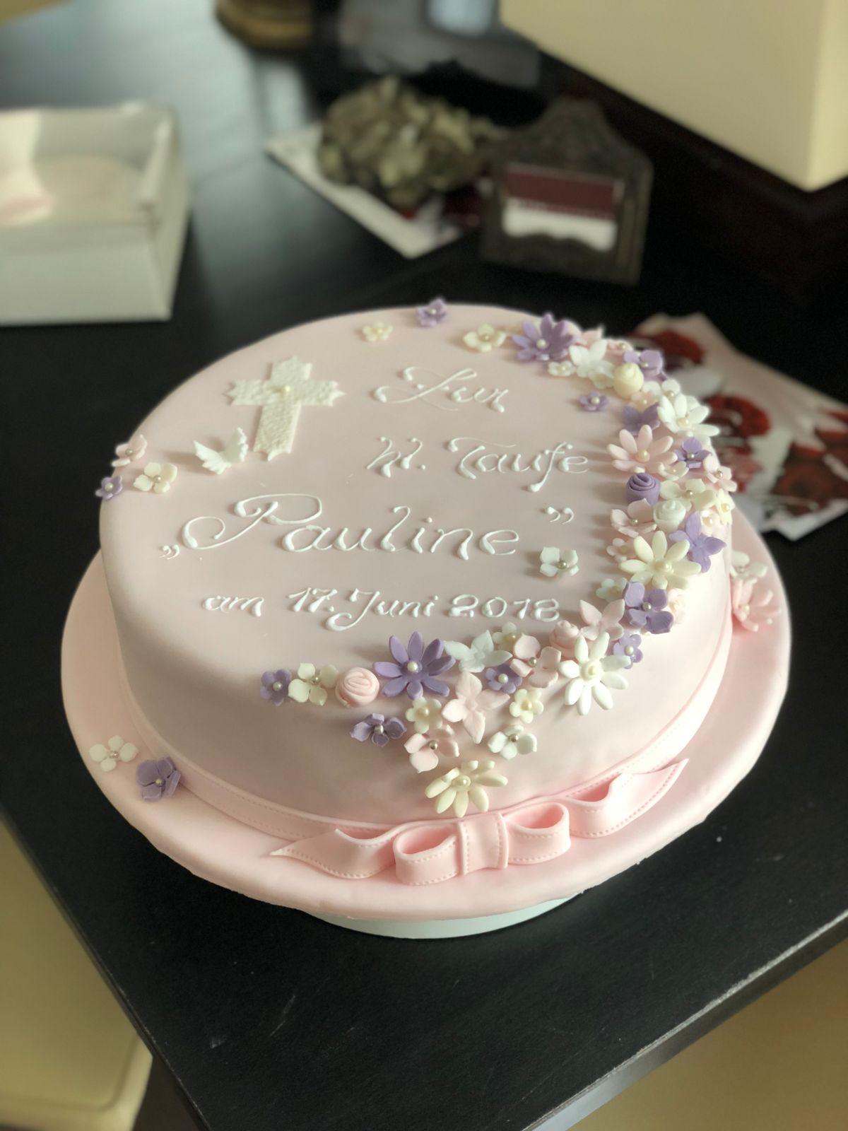 Christening cake with sugar flowers in white, pink and purple